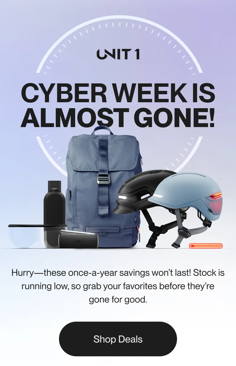 A promotional banner featuring a UNIT 1 blue backpack, two smart helmets (one black and one light blue), a water bottle, smart light, and visor. The message urges customers to act quickly as stock is running low during these once-a-year savings.