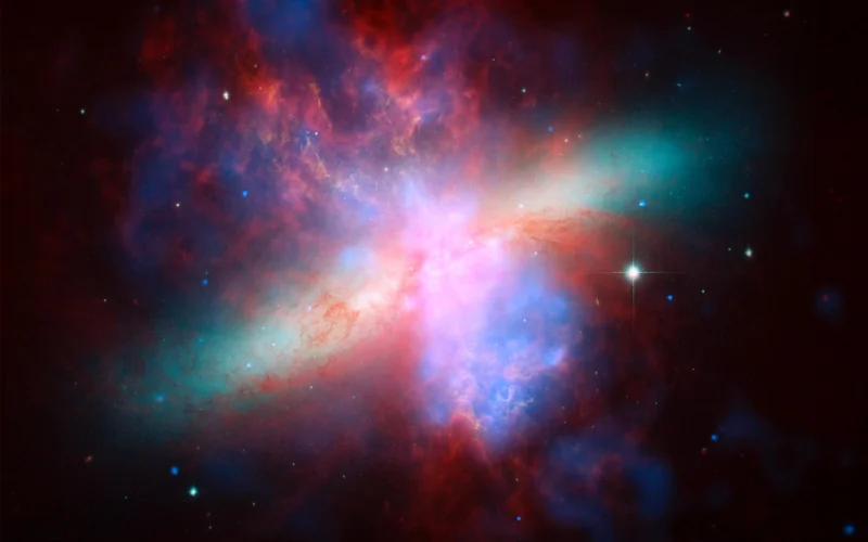 NASA Spitzer, Hubble and Chandra space observatories teamed up to create this multi-wavelength, false-colored view of the M82 galaxy.