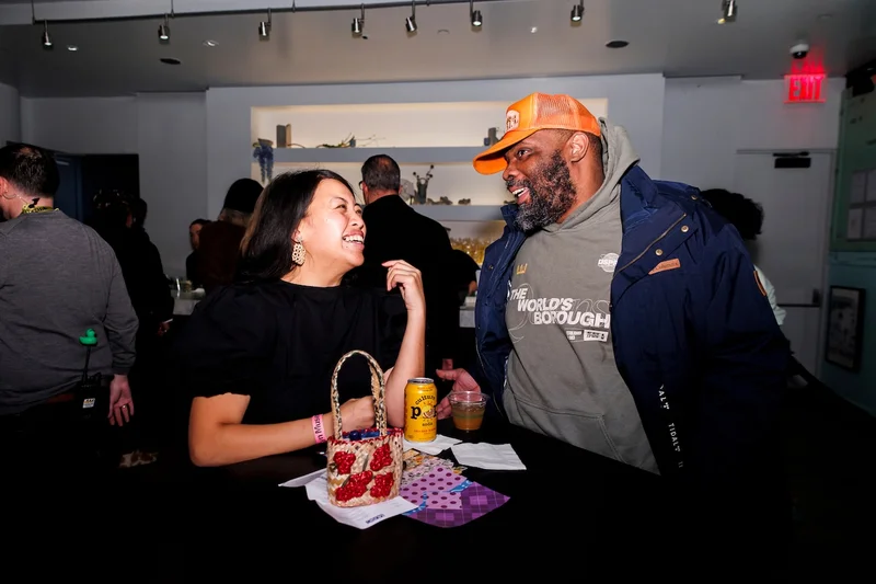 Two people smiling over drinks