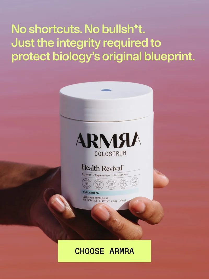 No shortcuts. No bullsh*t. Just the integrity required to protect biology’s original blueprint. CHOOSE ARMRA. Hand holding a white ARMRA Colostrum Health Revival jar against a pink-purple gradient background.