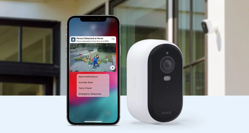 Arlo Essential 2K Outdoor Camera next to a phone displaying a simulated screen image of an Arlo Secure notification with animated preview.