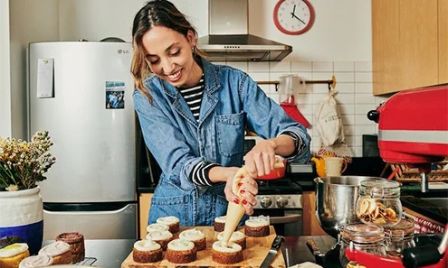 Photo of woman making cupcakes Photo of woman making cupcakes