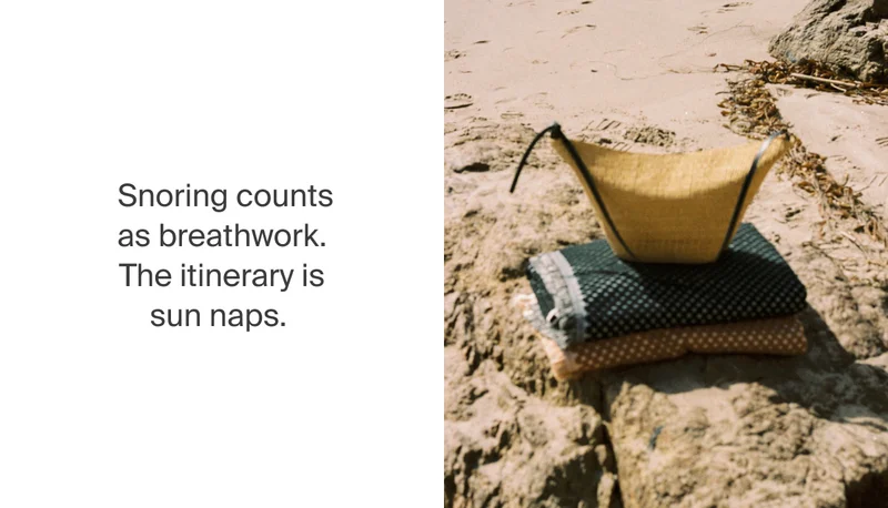 Straw bag and towels on the beach.