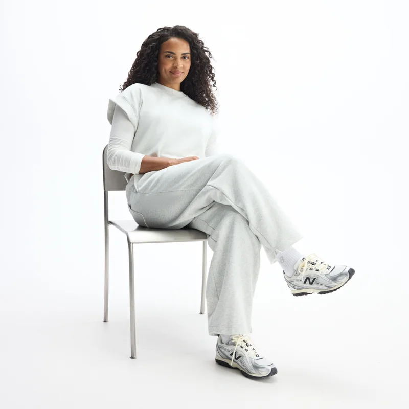 Sydeon sitting in chair pictured in head-to-toe New Balance apparel and 204L shoes (U204LSWD)