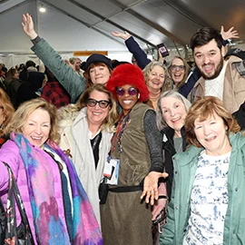 A group of Festival attendees smiling while waiting to enter a screening.