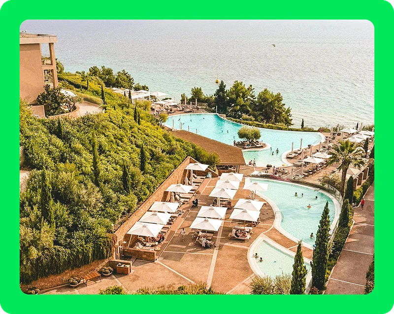 Image Description: A resort with two pools overlooking the water.