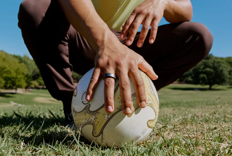 Person wearing Oura Ring holding a soccer ball