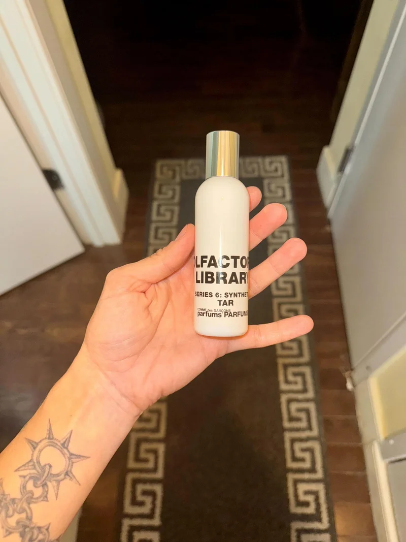 Image may contain: Bottle, Cosmetics, Perfume, Person, and Baby