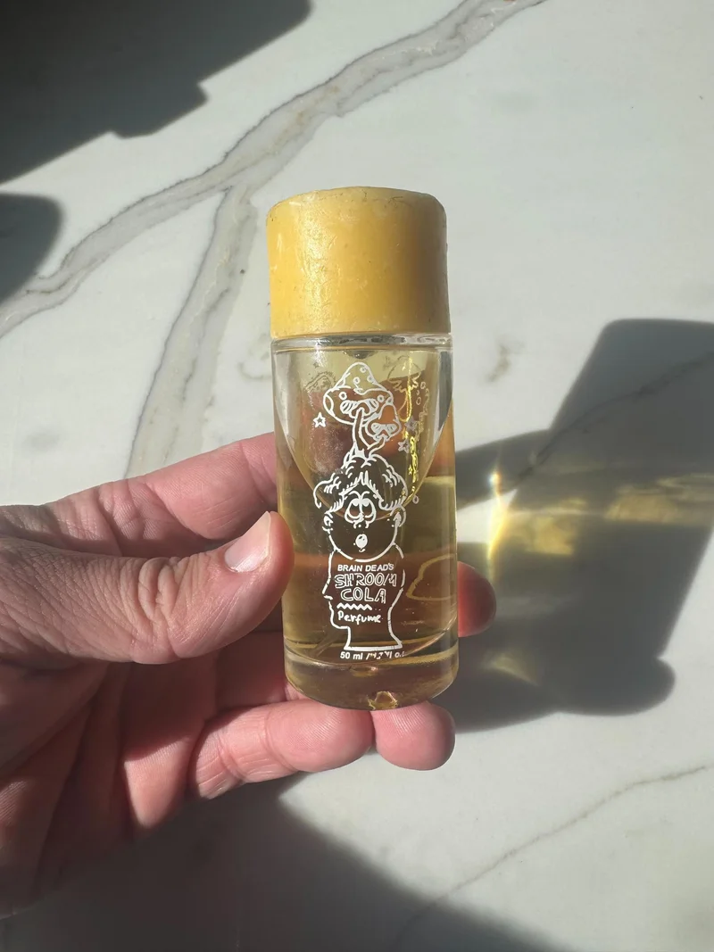 Image may contain: Bottle, Cosmetics, Perfume, Person, and Baby