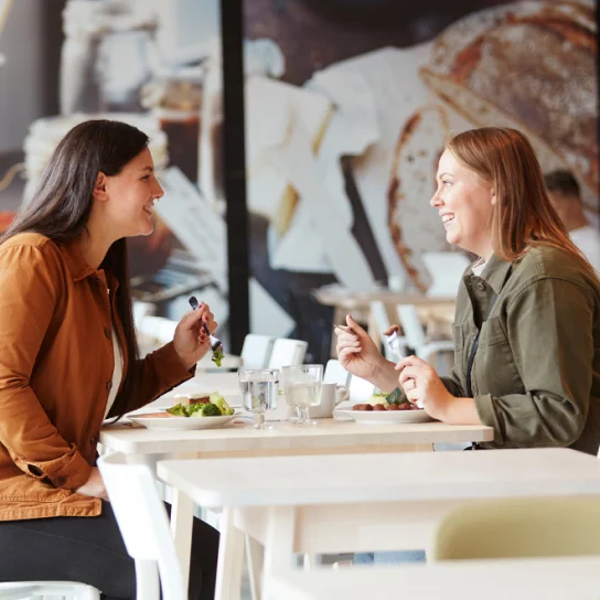 Two women enjoying a meal at IKEA