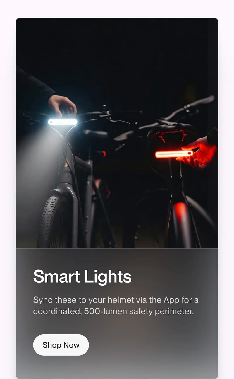 Two bikes with synchronized front and rear smart lights illuminated, shown with copy about app-connected 500-lumen safety lighting