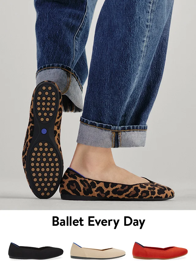 A woman wearing animal-print ballet flats with cuffed jeans. Beige, red and black flats.