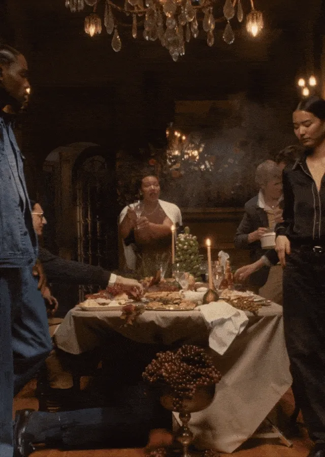 Group of people gathering by a holiday party dinner table