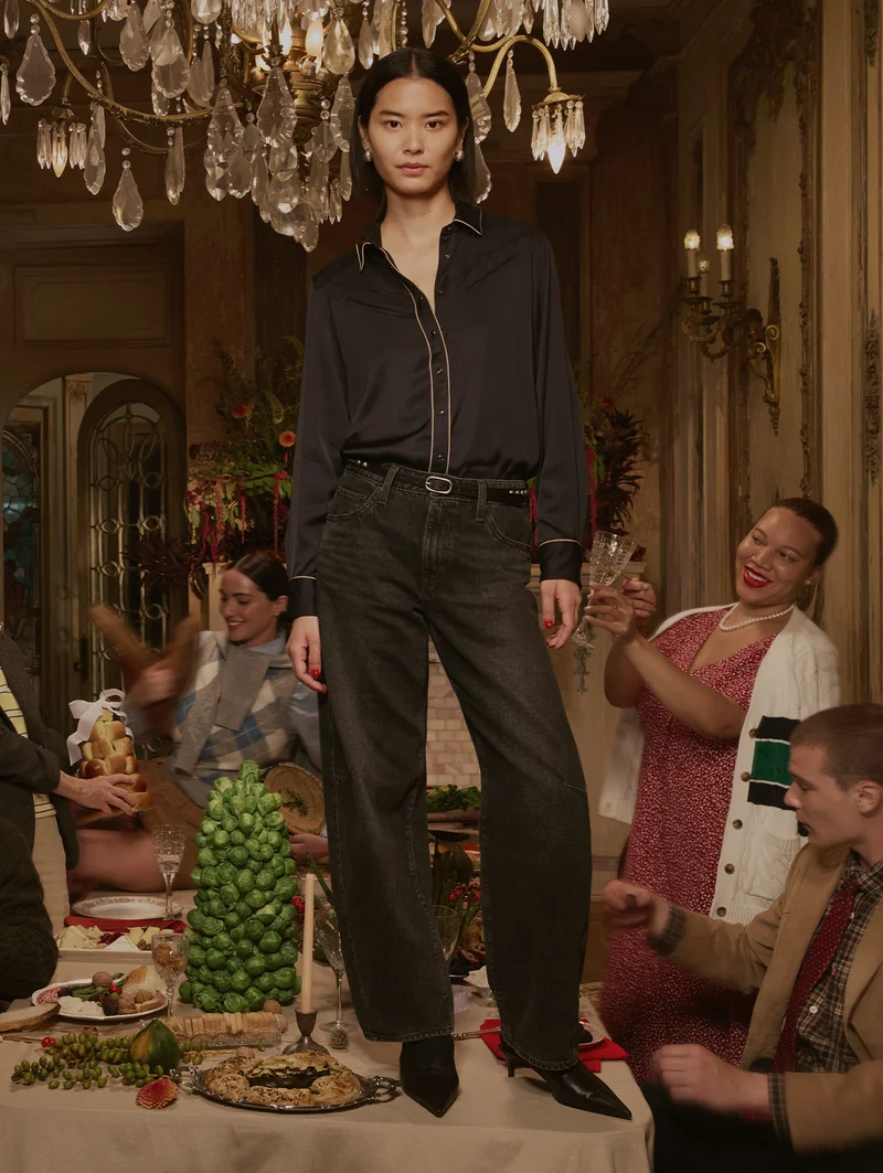 Person standing near a dinner table