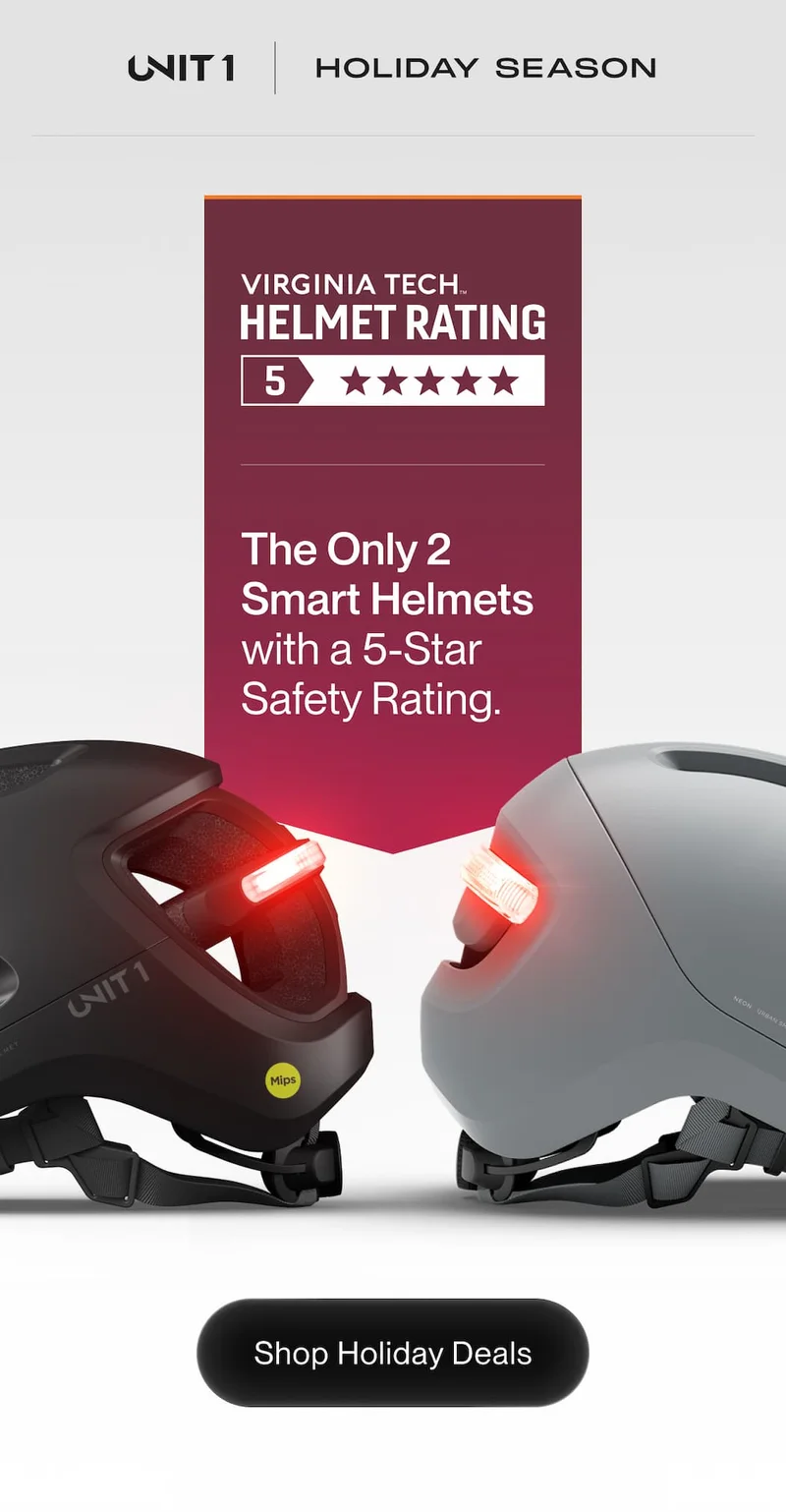 UNIT 1 helmets NEON and AURA facing each other with glowing rear lights. Banner reads: ‘The Only 2 Smart Helmets with a 5-Star Safety Rating.’ Button: Shop Holiday Deals.