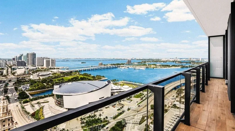 Image Description: A sprawling view of Biscayne Bay and downtown Miami from a balcony in The Elser Hotel, Miami