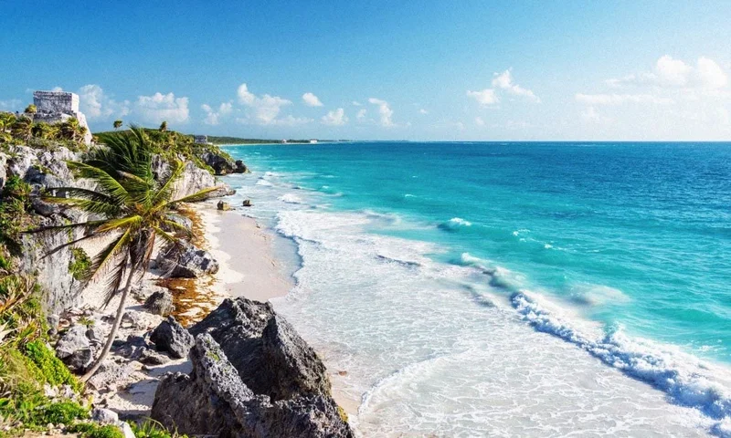 Image Description: A bird’s eye view of the Mayan Ruins in Tulum next to the Caribbean coastline, which makes a popular day trip from Cancun