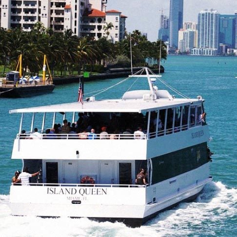 Image Description: A two-story yacht sailing down Biscayne Bay towards Millionaire's Row in Miami