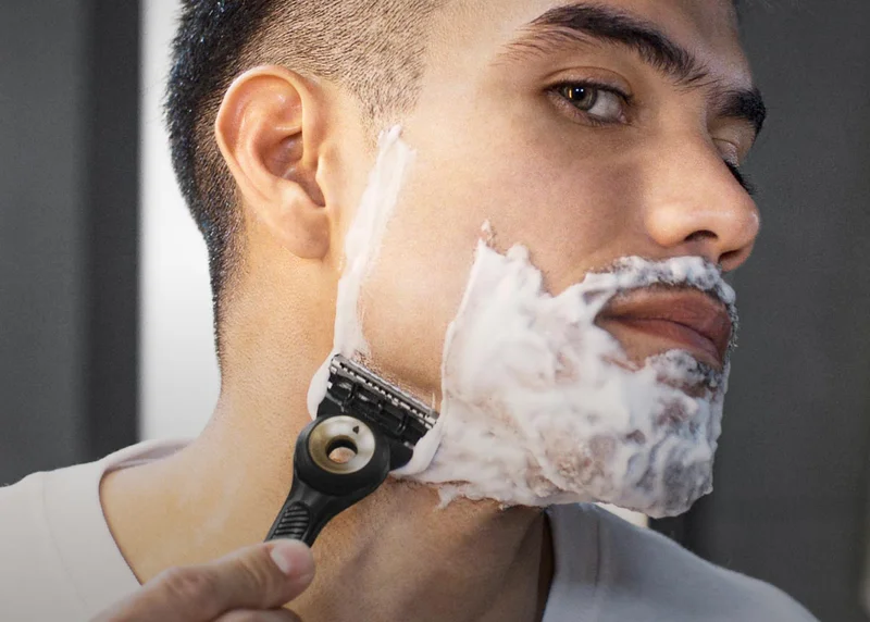 Man shaving with face with GilletteLabs with exfoliating bar razor