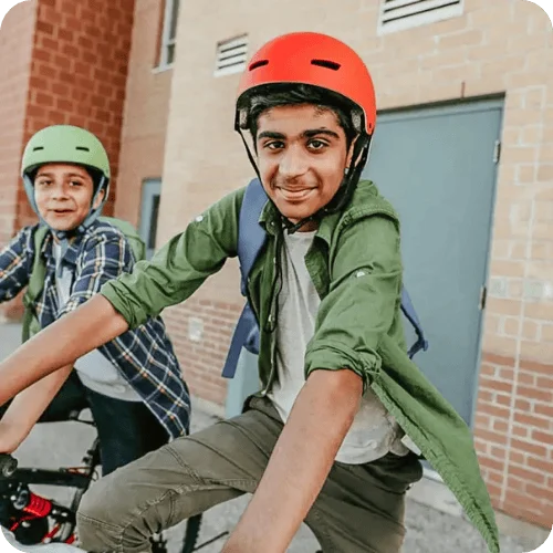two tween boys biking with helmets on two tween boys biking with helmets on