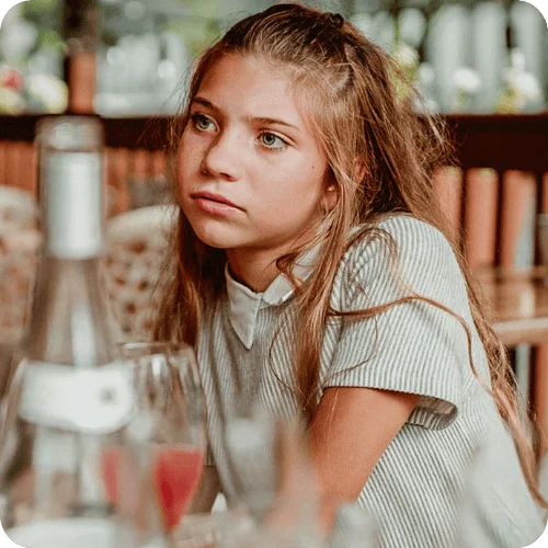 a teen girl looking annoyed at her parents a teen girl looking annoyed at her parents