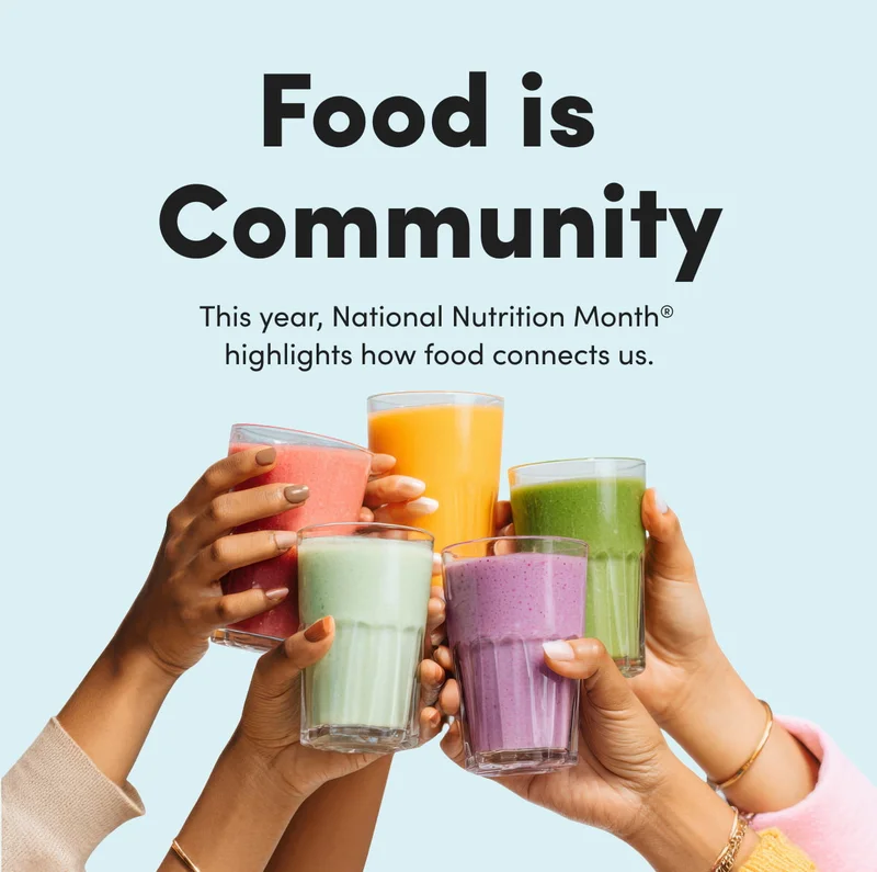 Five hands of diverse skin tones holding up various colorful smoothies in a celebratory toast against a light blue background.
