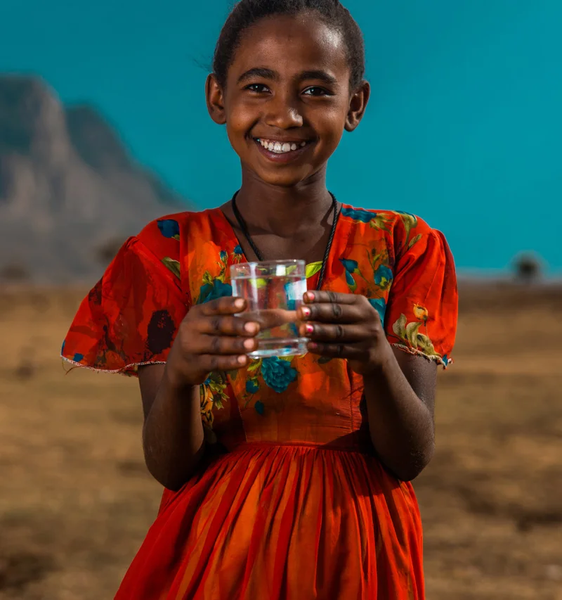 Girl holding glass of water