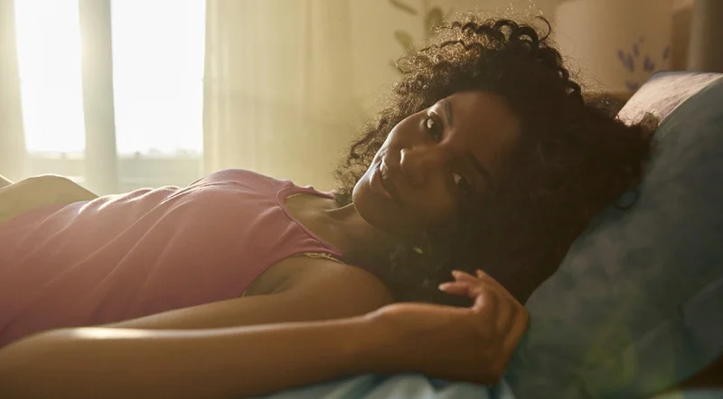 Woman laying on Purple brand mattress