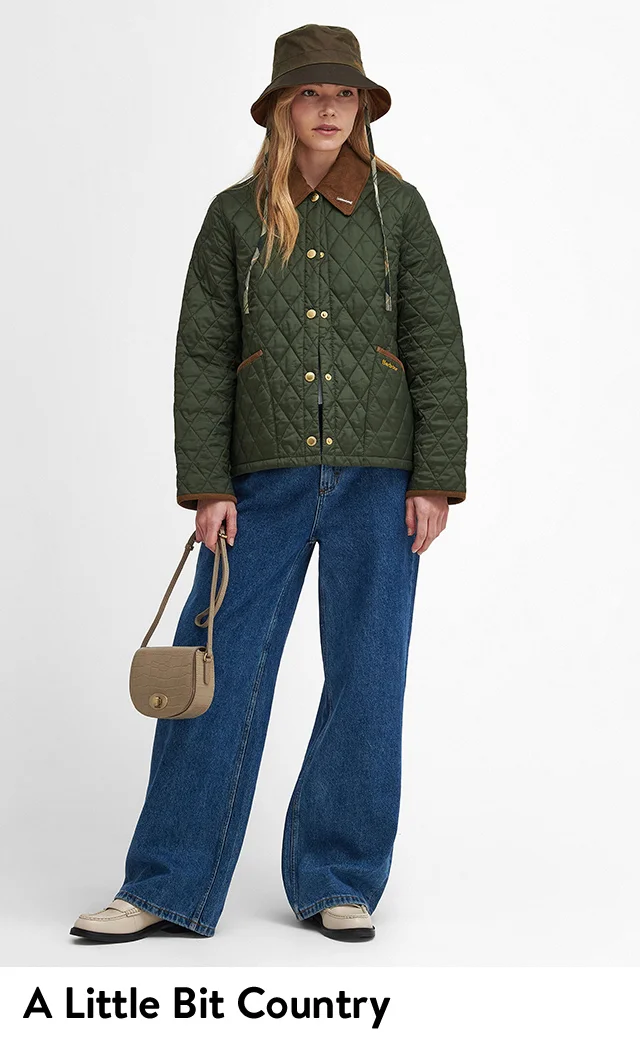 A woman wearing a green quilted jacket with jeans.
