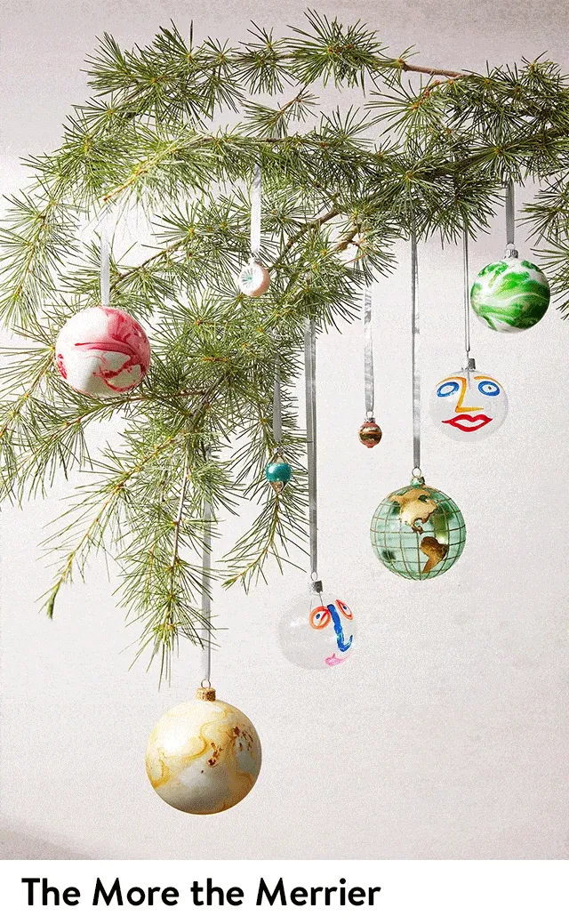 Assorted ornaments hanging from a tree and gathered on a table.