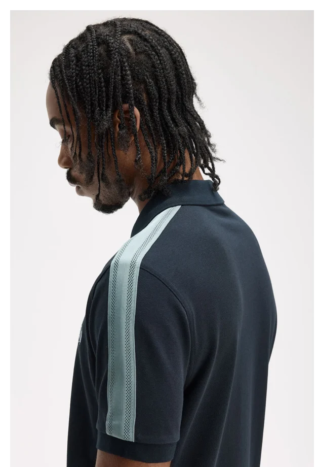 Male model wearing a Fred Perry Mesh Taped Polo Shirt in Navy