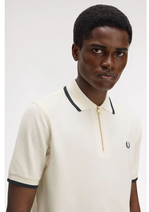 Male model wearing a Fred Perry Crepe Piqué Polo Shirt in Silky Peach