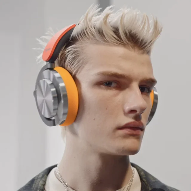 A model wearing Dyson OnTrac headphones in custom color combo