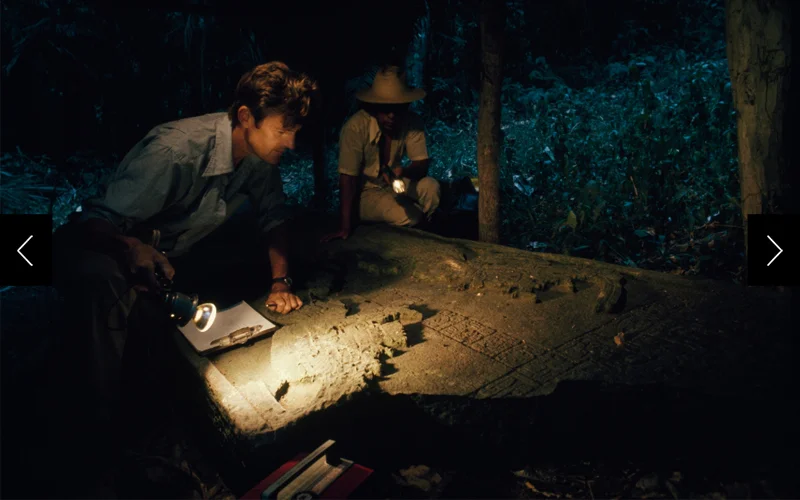 Seeking keys to the past, Ian Graham plays lights across eroded details of a stela at Yaxchilán, Mexico.