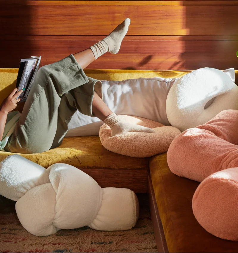 woman on couch surrounded by Buffy pillows