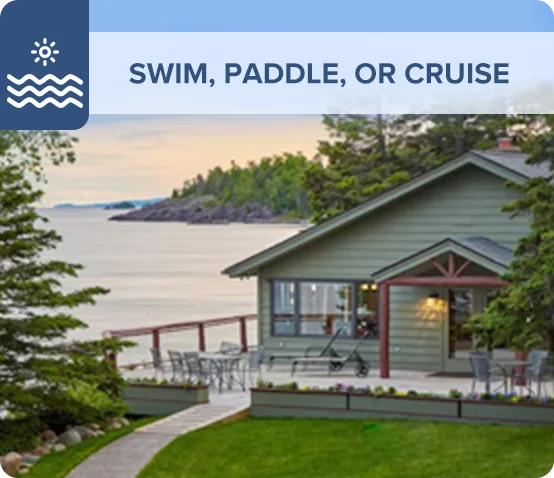 Lakefront home with a spacious patio overlooking calm waters and trees.