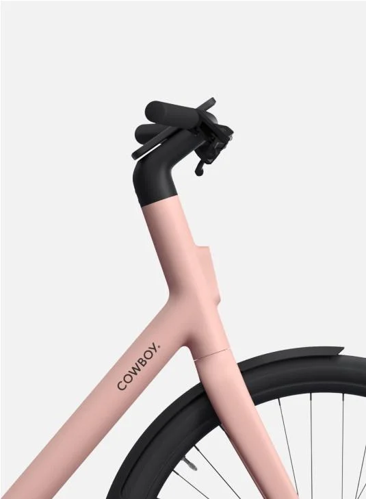 A photographic render. From the side, detail of the front wheel and handle bars of a Cowboy Cruiser ST in Fig colourway