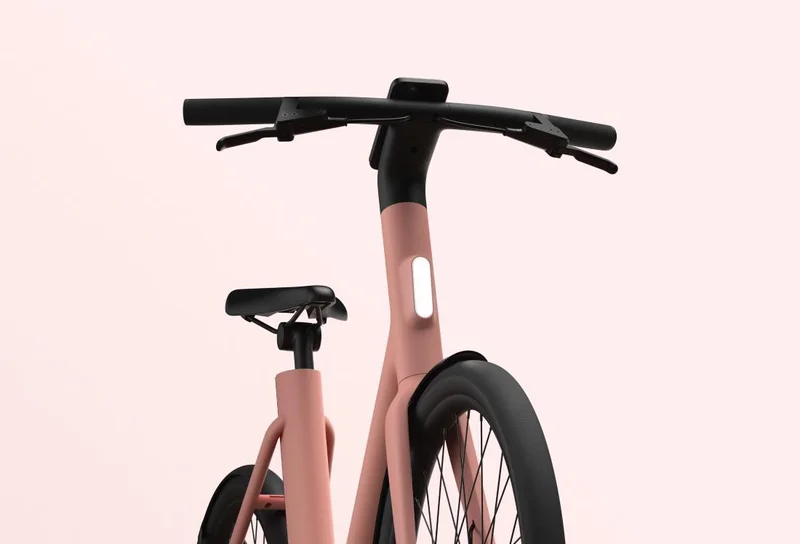 A photographic render. A Cowboy Cruiser ST in Fig colourway from a low front angle.
