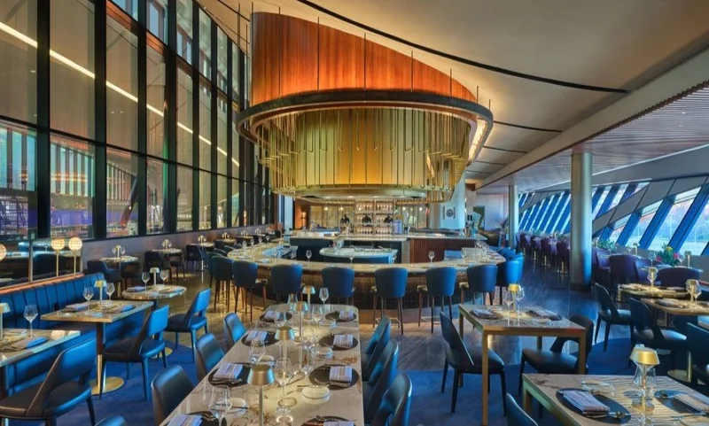 A photo of the bar and seating area at the Delta One Lounge Boston