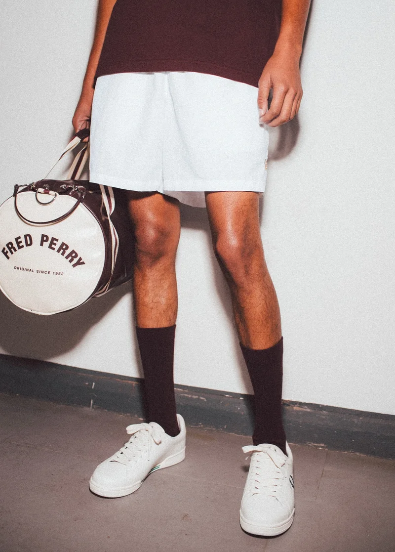 Fred Perry Barrel Bag and White Trainers