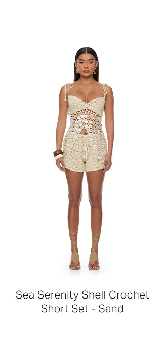 Model in a Sea Serenity Sand Shell Crochet Short Set, featuring intricate top with white shell details. Ideal for beachwear.