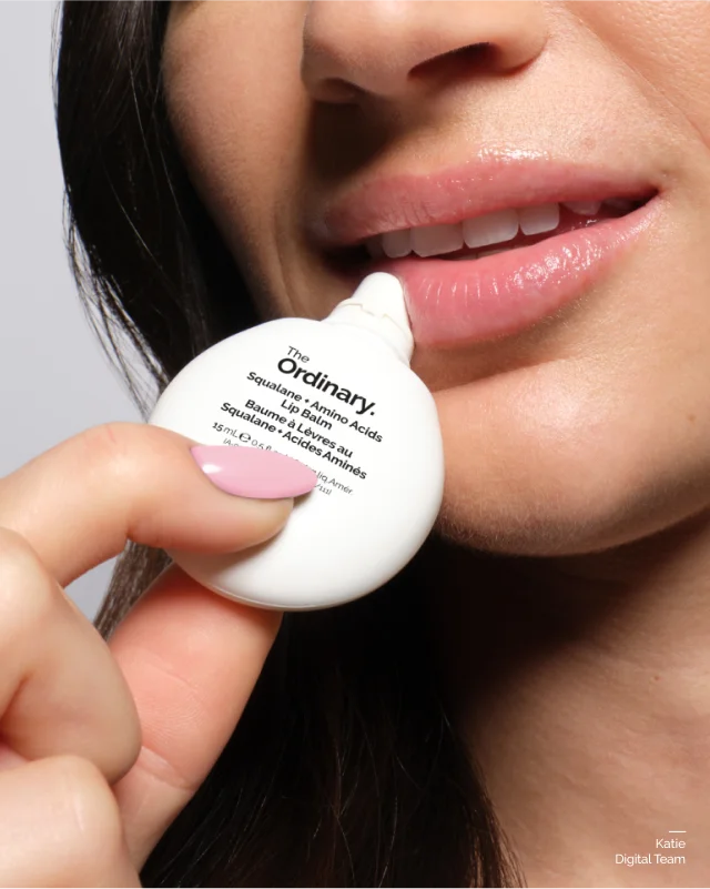 Kaite applying Squalane + Amino Acids Lip Balm
