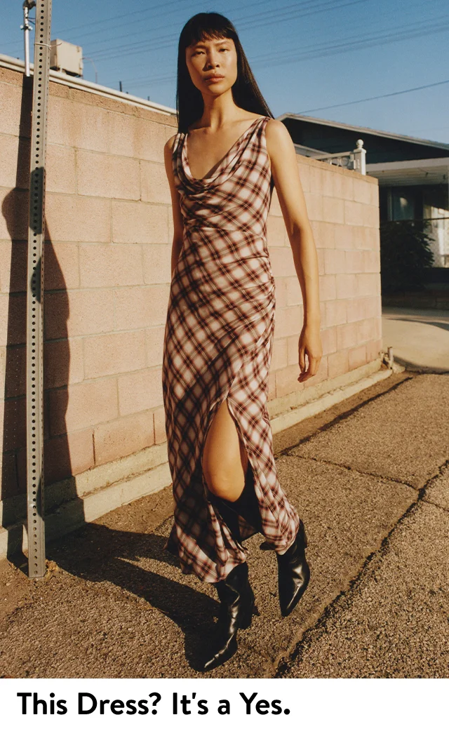 A woman wearing a long sleeveless dress.