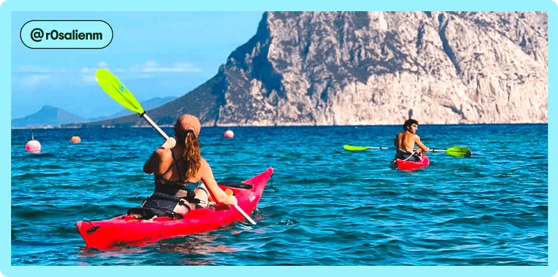 Image description: Two travelers kayaking in the ocean near pink buoys, photo taken by @r0salienm