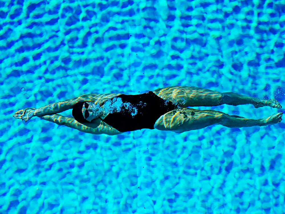 Katie Ledecky in blue water of a swimming pool