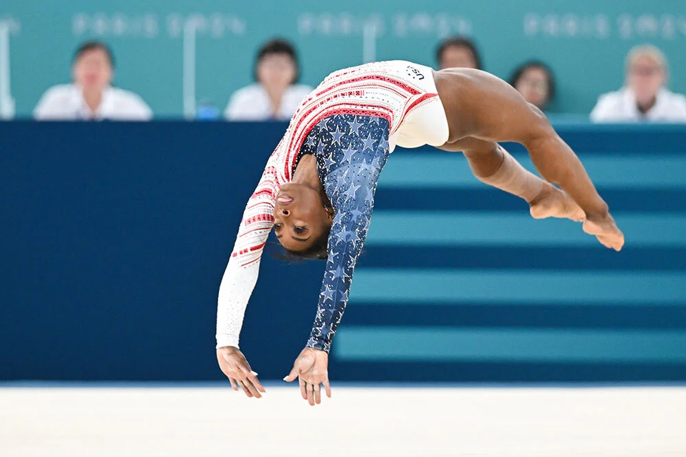 Simone Biles performing on floor at the 2024 Paris Olympics.