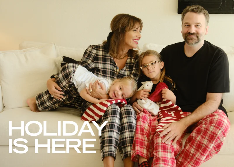 jillian harris wearing green shay romper next to christmas trees