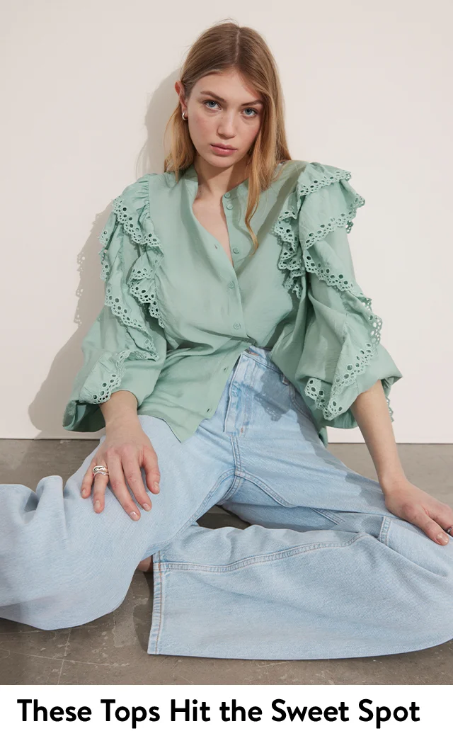 A woman wearing an eyelet top.