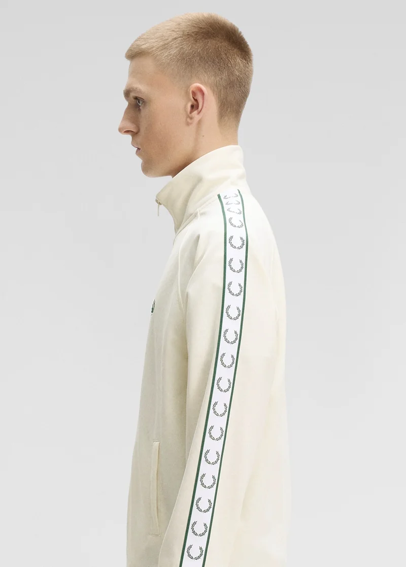 Side view of a male model wearing a Fred Perry Contrast Tape Track Jacket in Ecru