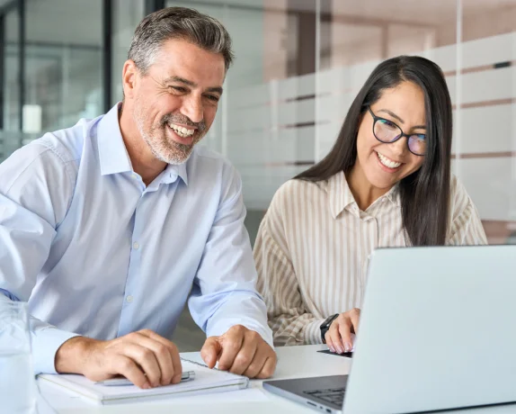 Business partners viewing a laptop